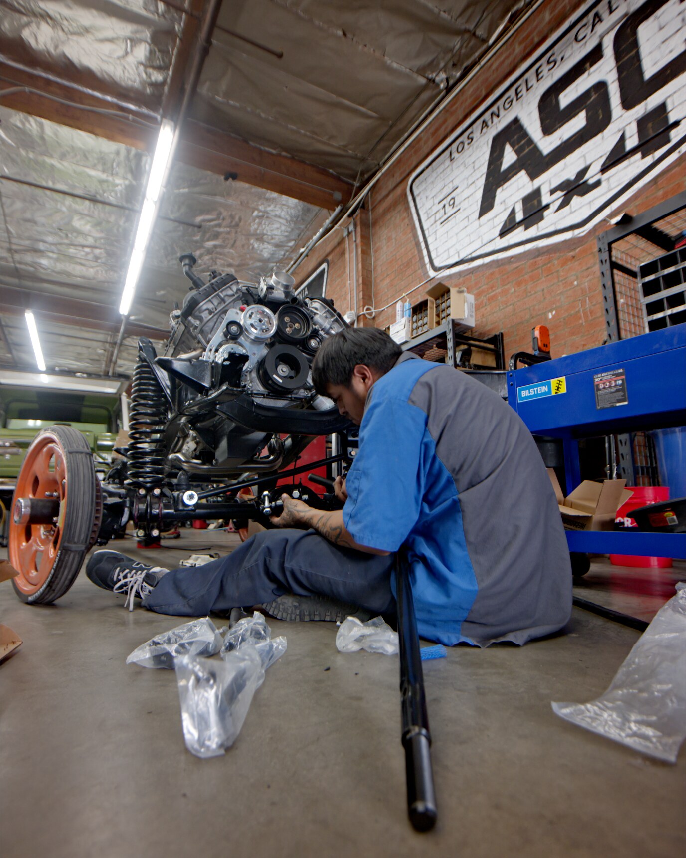 ASC 4x4 technician assembling a vintage 4x4 chassis in the shop